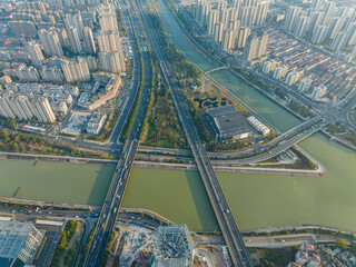 Aerial view of modern urban district with highways bridges and canal © VuVan