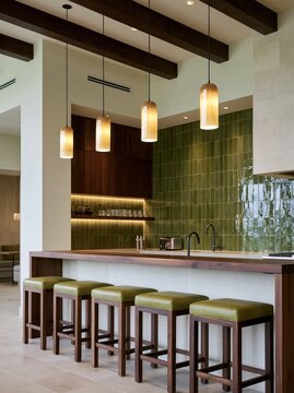 Modern Kitchen Island with Bar Stools: A stylish kitchen island with a wooden countertop and green upholstered bar stools, illuminated by modern pendant lights.