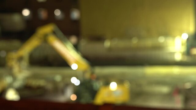 A cinematic nighttime video clip of an industrial drilling machine at a construction site.
