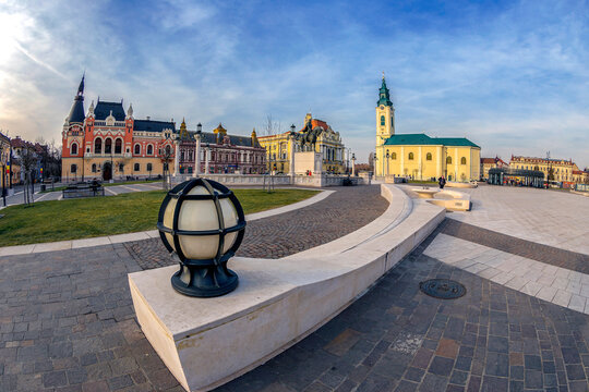 ORADEA,ROMANIA-JANUARY 27,2018:The Union Square with historical buildings. City Hall,Palace of the Greek Catholic Episcopate,Kovacs House,Roman Catholic Church St.Ladislau,statue of Michael the Brave.