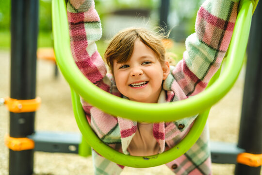 Happy child girl on playground on summer season
