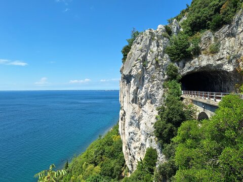 Natural rock tunnel on the Strada Costiera overlooking the Adriatic Sea near Trieste, Italy