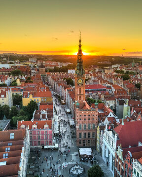 Aerial view of the historic Main Town Hall and Long Market with red rooftops during a golden sunset Gdansk, Pomeranian Voivodeship, Poland.