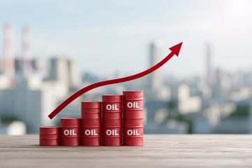 Red oil drums stack upward with bold arrow trending higher. City skyline softly blurred in background, hinting global scale. Bright daylight enhances visual clarity and professional tone © lashkhidzetim
