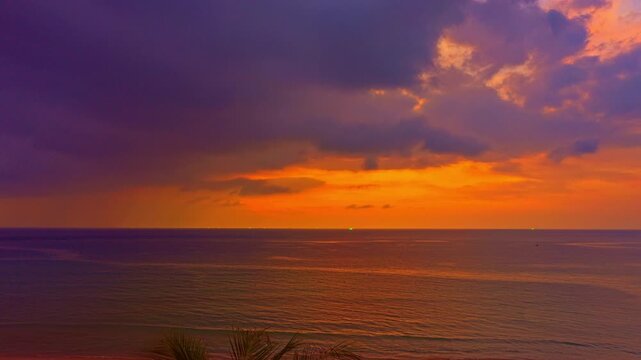 
This tropical beach scene showcases a breathtaking sunset sky gradient above coconut trees, where changing light and drifting clouds create a mesmerizing time-lapse display.