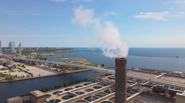 flying counter clockwise around smokestack revealing downtown Milwaukee