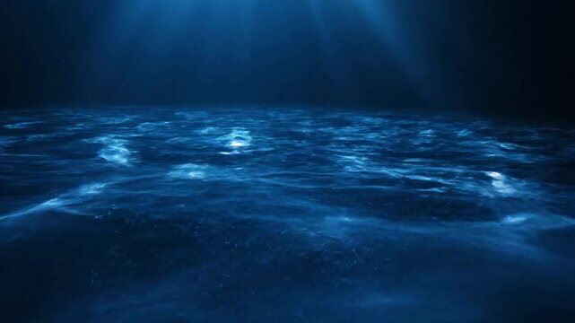 Underwater ocean surface with caustics reflects sunrays shining through blue sea or Deep dark ocean environment with sunbeams and light filtering through water surface