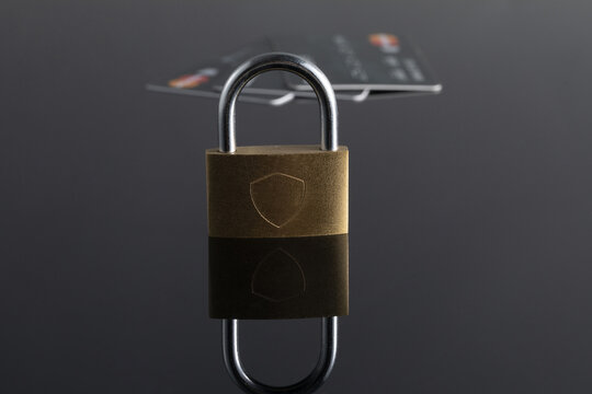 Padlock and payment cards symbolizing financial security and fraud protection