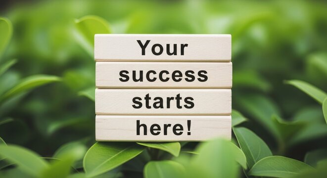 Motivational wooden blocks with success message in green leaves