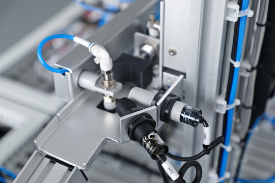 Industrial automation sensors and pneumatic components on manufacturing equipment