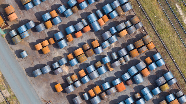 Aerial view of Tata Steel industrial site with rows of large steel coils and railway tracks in Velsen-Noord, Noord-Holland, Netherlands.