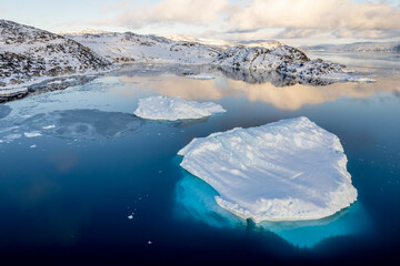 Drone view of white iceberg and turquoise blue ice below the surface in calm arctic water fjord near Ilulissat, Avannaata, Greenland © vadim.nefedov