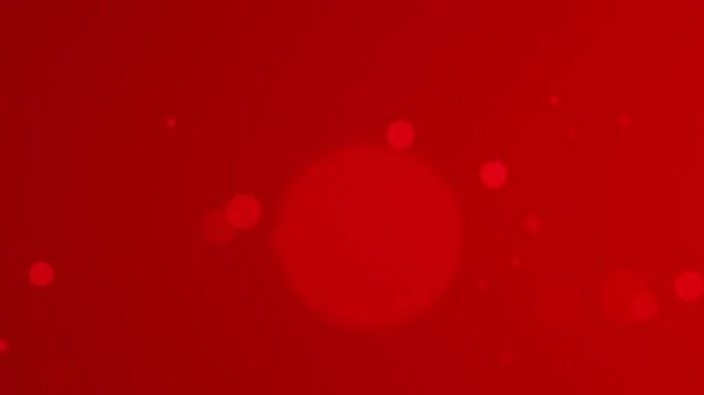 Slow motion of blurry bokeh circles with varying sizes on red surface 