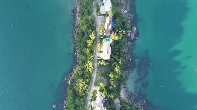 A paradisiacal cape with clear tropical waters and buildings. Praia da Boa Vista (Ubatuba) Brazil