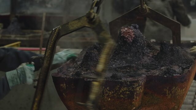 Metalworking Environment Showcasing Worker Maneuvering Crucible Across Overhead Crane System. Stock Clip