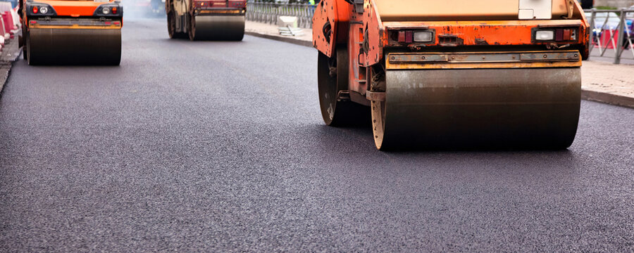 Paving a City Street With Asphalt Concrete for Road Repairs and Improvements in Urban Areas