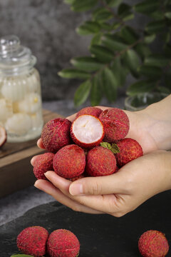 Fresh Guangxi Lychees in Hand with Hainanese Drink