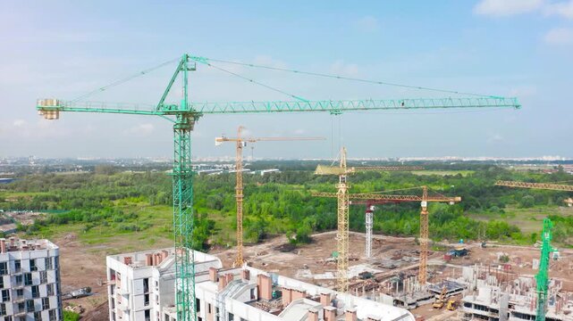 Construction site activity with tower cranes at residential development in an urban setting
