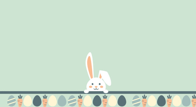 Cute Easter bunny peeking over a border of colorful eggs and carrots on a soft green background