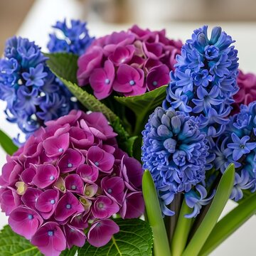 Vibrant bouquet of purple hydrangeas and blue hyacinths, with green leaves
