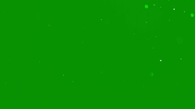 Beautiful slow motion snow dust with soft light particles on a green background. Perfect for Christmas visual, winter intro, cinematic overlay, motion design project. White snowflakes falling isolated
