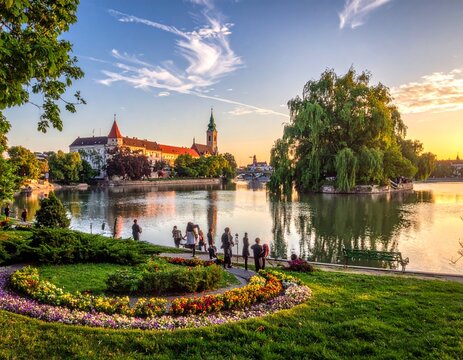 Lakeside park with castle at sunset