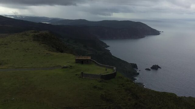 Aerial view of Garita de Herbeira stone hut on the edge of high cliffs overlooking the Atlantic Ocean in Meizoso, A Coruna, Spain.