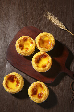 Macau Egg Tarts Portuguese Pastry Dessert with Creamy Custard Filling on Wooden Board