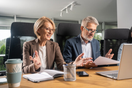 Smiling people, in the meeting room, using a laptop, searching