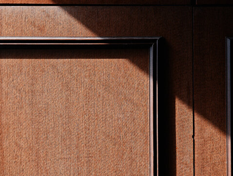 Ray of light on brown wooden furniture backdrop