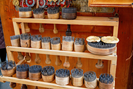 Traditional embroidery tools used for zardozi craft in Bukhara, Uzbekistan, wooden implements with metal pins displayed in artisan workshop
