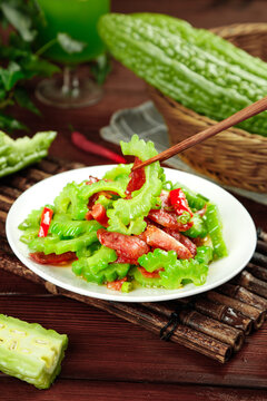 Shandong Weifang bitter melon stir-fry with fresh sausage and green vegetables on bamboo mat