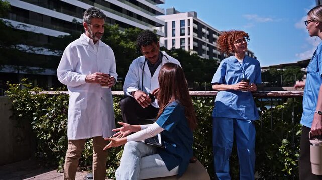 Diverse team of doctors and nurses socializing outside the hospital