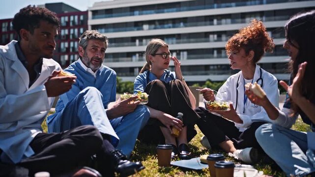 Medical team having lunch break outside hospital