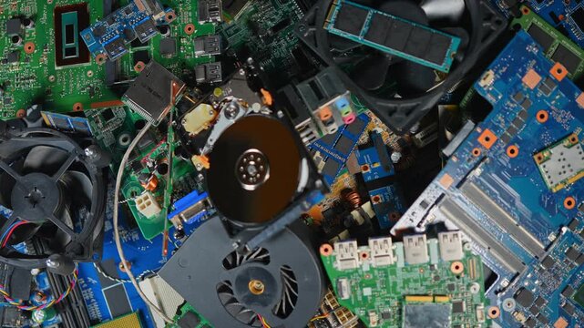 Aftermath of AI booming economy, e-waste pile of computer components with valuable rear earth metals, sustainability issues. Data centers powering AI upgrades and equipment replacements concept.