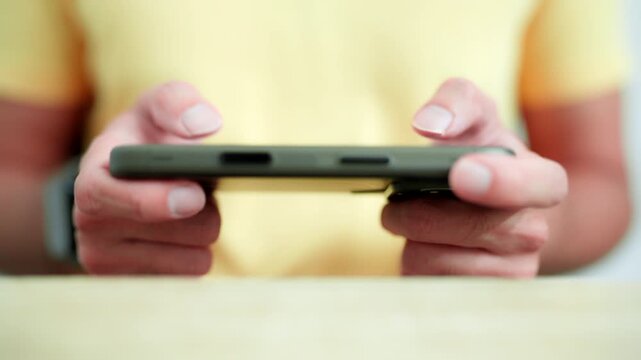 Man Playing Mobile Game on Smartphone Close Up.