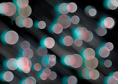 A delicate festive bokeh abstract background with circles of light and motion blur on a black background