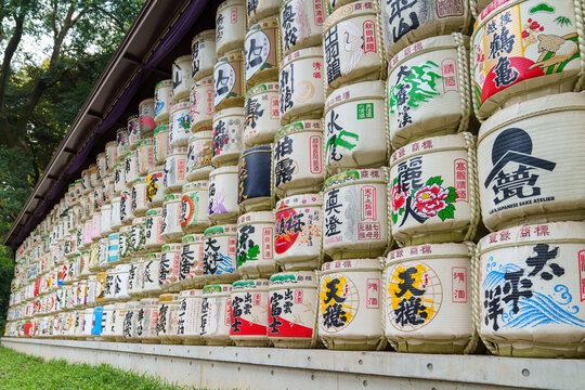Tons of barrels of sake called Kazaridaru decorated with various patterns and inscriptions at Meiji Temple, Tokyo, Japan