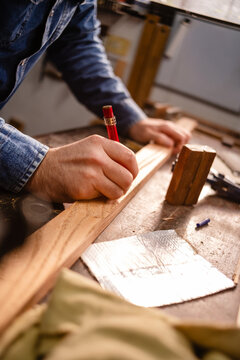 close up of hands working on a wooden board