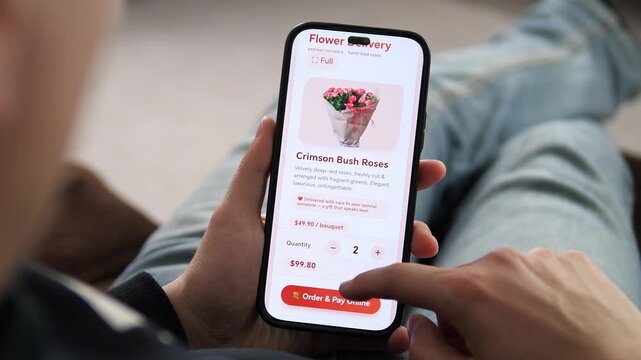 Browsing a flower delivery app on a smartphone. The screen displays Crimson Bush Roses with a price of 49.90 dollars and a description. Perfect for e-commerce, gift delivery, and Valentines Day