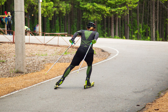 Cross Country Skiling. A man in the park runs on ski rollers.