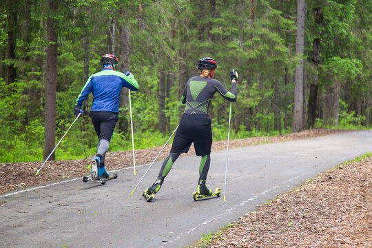 Cross Country Skiling. A man in the park runs on ski rollers.