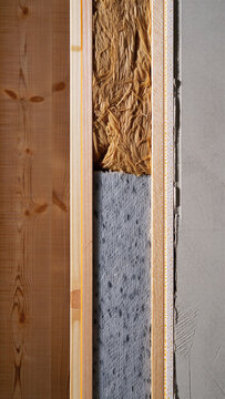 Cross section of a modern wall assembly showing wooden studs insulation material and concrete support layer with insulation construction concrete building structure material efficiency