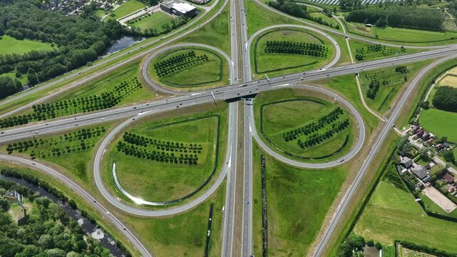 Aerial view of the symmetrical cloverleaf highway interchange with green grass and trees Heerenveen, Friesland, Netherlands.