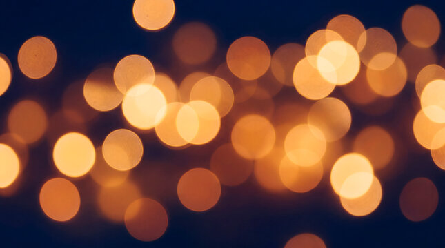 Defocused warm golden bokeh lights on deep blue holiday background for festive overlay
