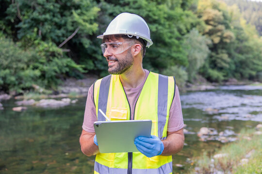 Environmental engineer monitoring river water quality and pollution