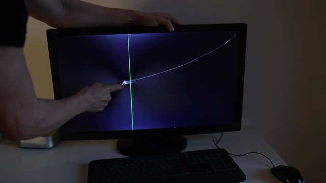 Angry young man scratches a glowing computer monitor after losing money in cryptocurrency trading expressing frustration financial stress and investment failure