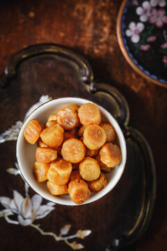Dried Scallops in Bowl on Dark Wooden Table