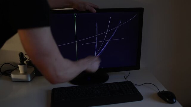 Young man scratches a computer monitor after a failed cryptocurrency trade while the glowing screen displays financial stress frustration and investment loss emotions