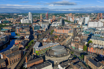 Obraz premium Leeds city centre, West Yorkshire, England. Aerial view of the historic landmark surrounded by commercial buildings, streets and urban development.